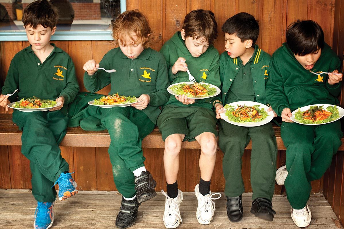 school kids eating pasta cooked with sandy cookbook